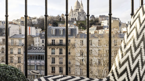 A view of a cityscape with a prominent domed building in the background.