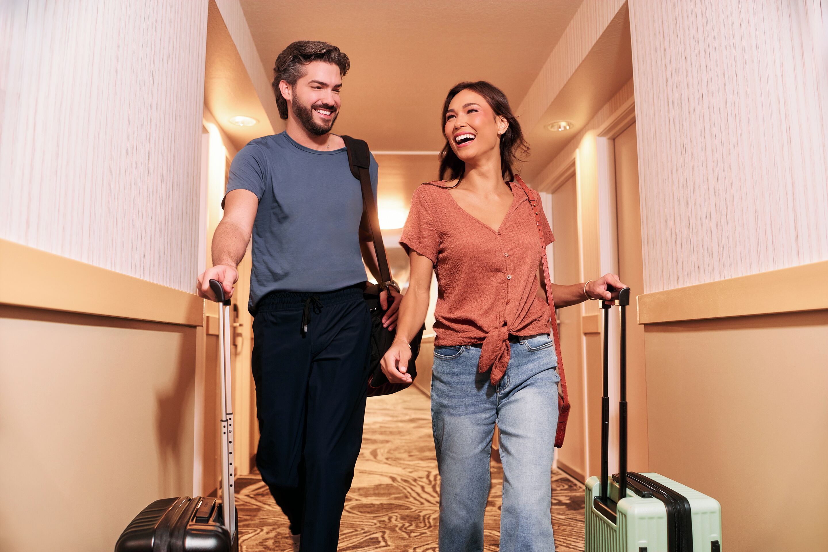 A hallway with wooden paneling and a carpeted floor.