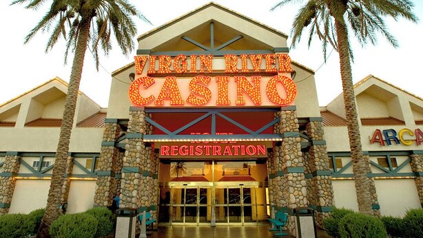 Außenansicht des Virgin River Casino mit einem Registrierungsbereich, einer Steinfassade und Palmen.