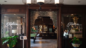 A lounge and sports bar with a billiards table, potted plants, and framed artwork. - The Bayview Hotel Pattaya (Pattaya)