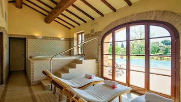 Relax in a serene spa room with a view of the outdoor pool and enjoy a massage on one of two available tables.