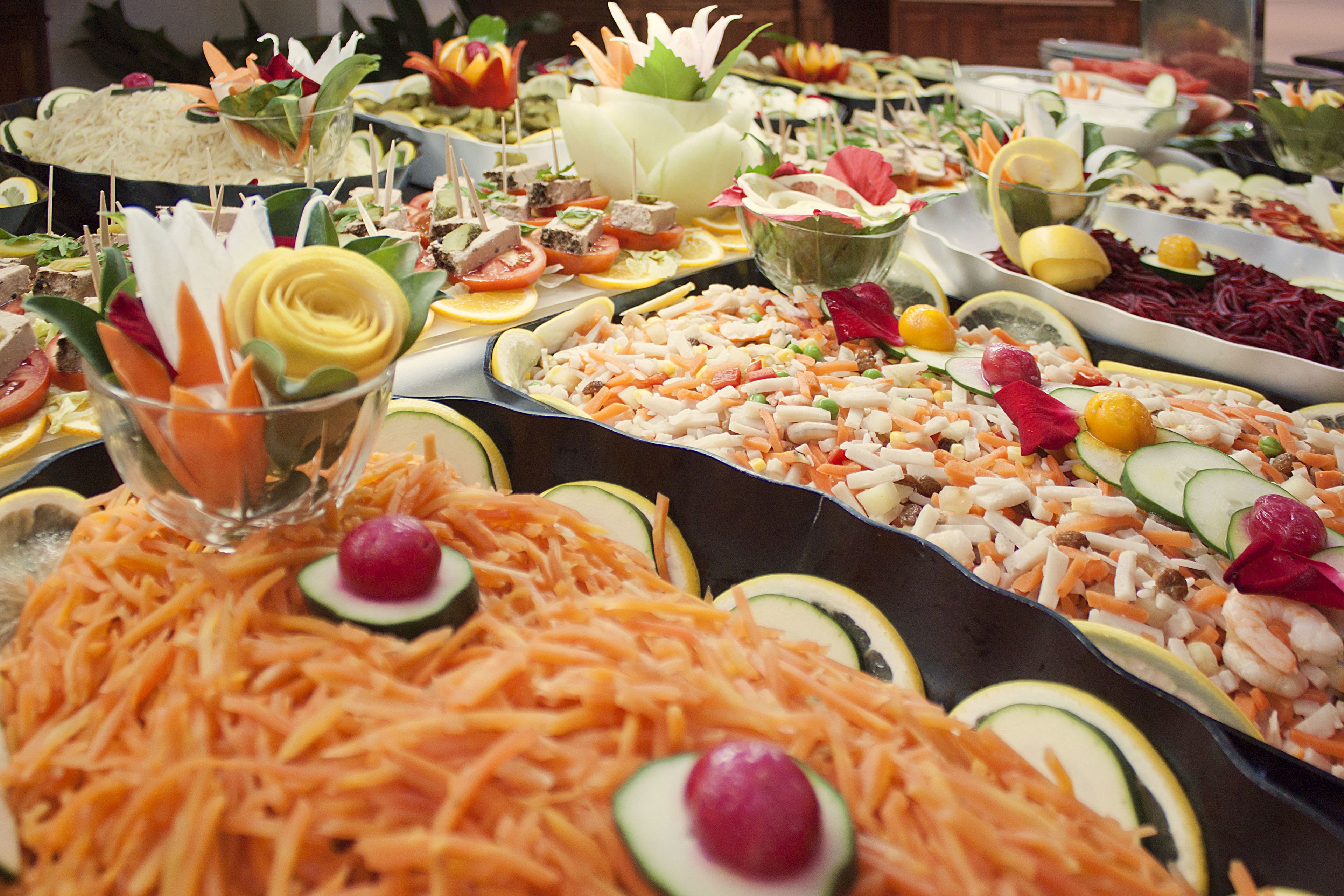 A buffet with various food items and garnishes.