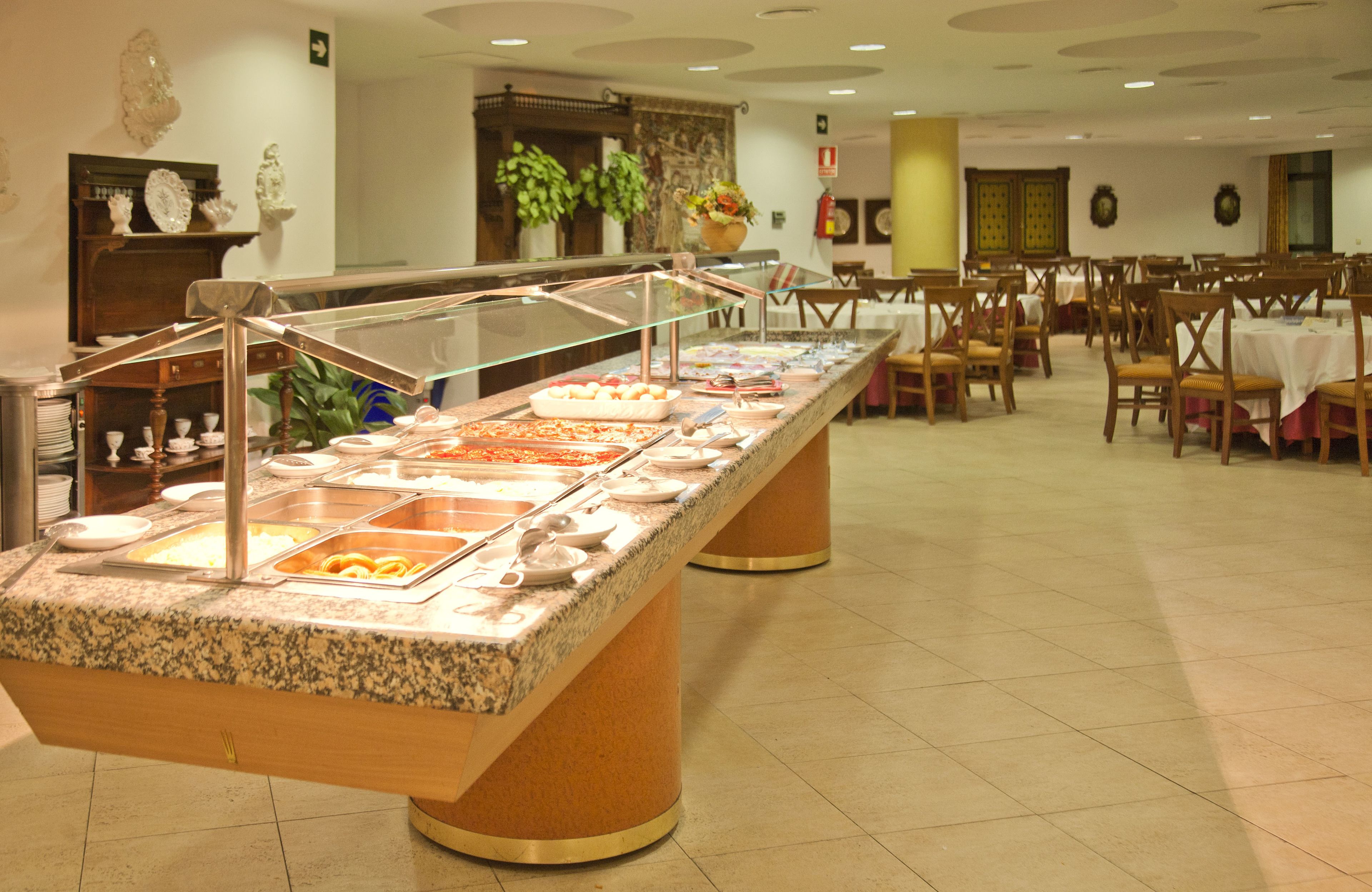A buffet setup with multiple food stations, a variety of dishes, and a clean, organized layout.