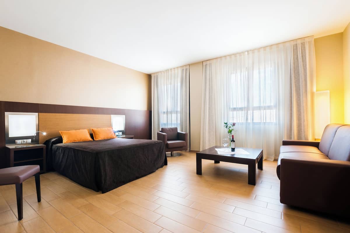 family room | 1 bedroom, minibar, in-room safe, desk