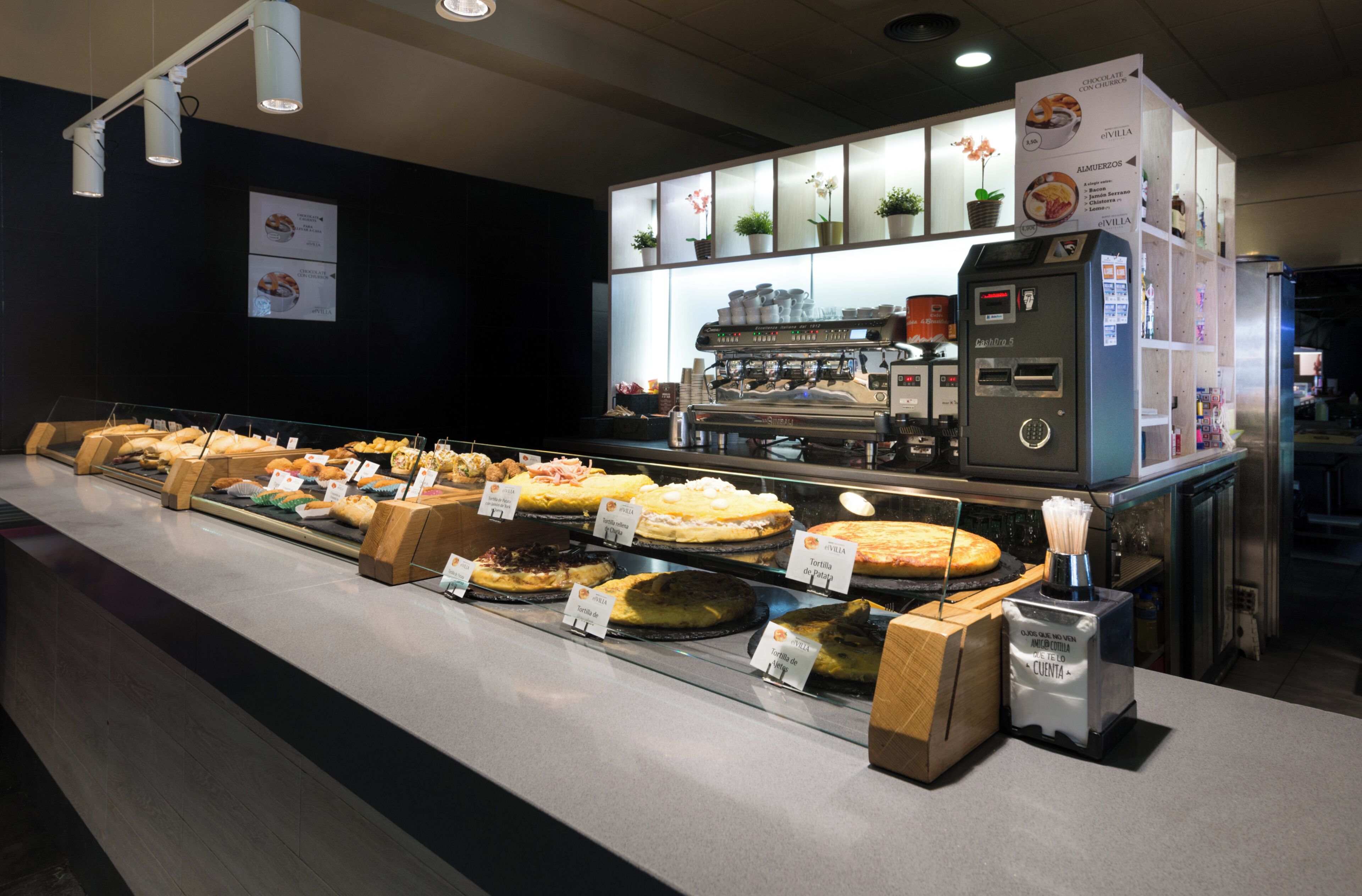 A bakery display with various baked goods and a coffee machine.
