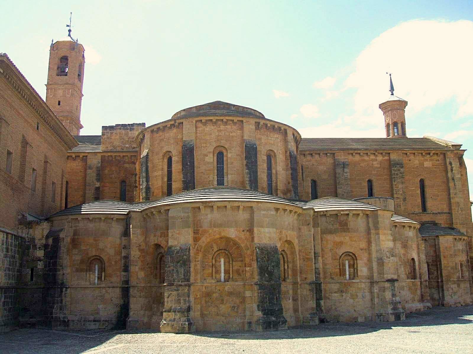 A historic building with a central dome, arched windows, and two bell towers.