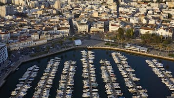 A marina with numerous boats docked in a cityscape.