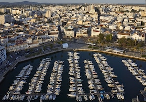 A marina with numerous boats docked in a cityscape. - Occidental Faro (Faro)