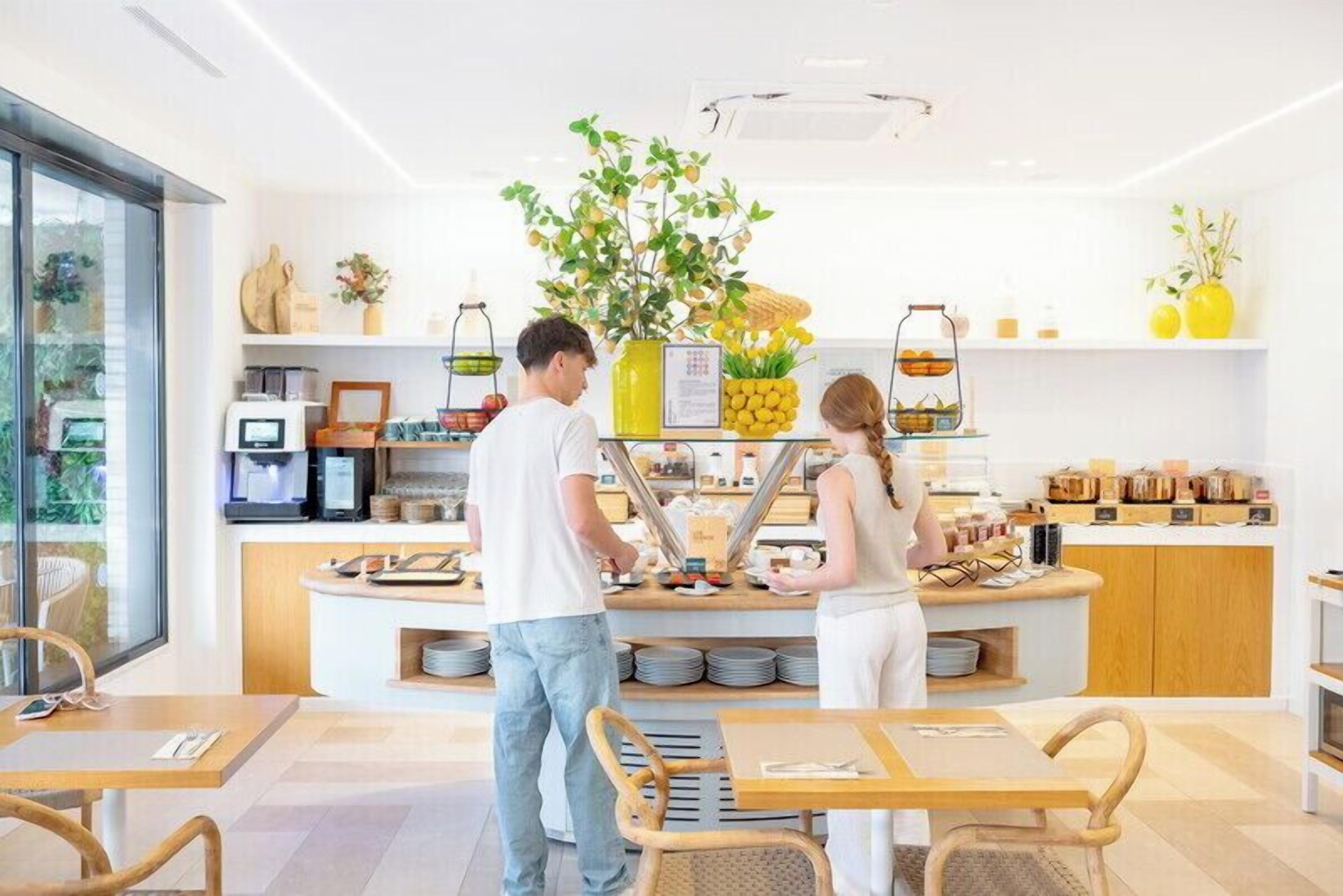 Un café moderno con mostrador, zona de estar y vistas al exterior.
