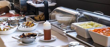 A buffet setup with various food items and beverages.