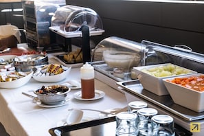 Enjoy a diverse selection of food and drinks at our buffet, featuring fresh fruits, nuts, soups, and a variety of dishes.