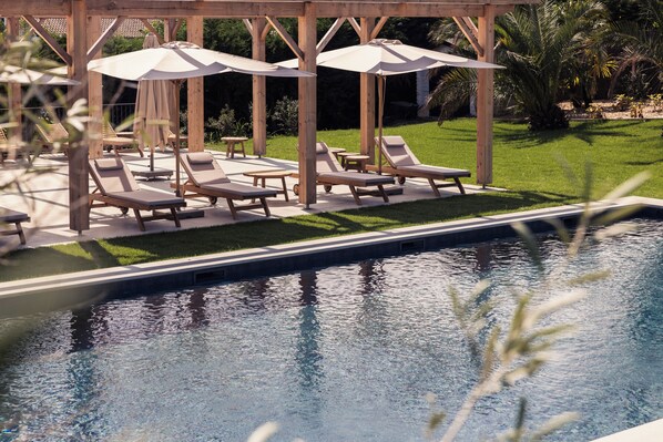 Seasonal outdoor pool, open 9:00 AM to 8:00 PM, pool umbrellas