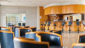 A hotel lobby with a bar area, seating, and a reception desk. - Hotel do Mar (Povoacao)