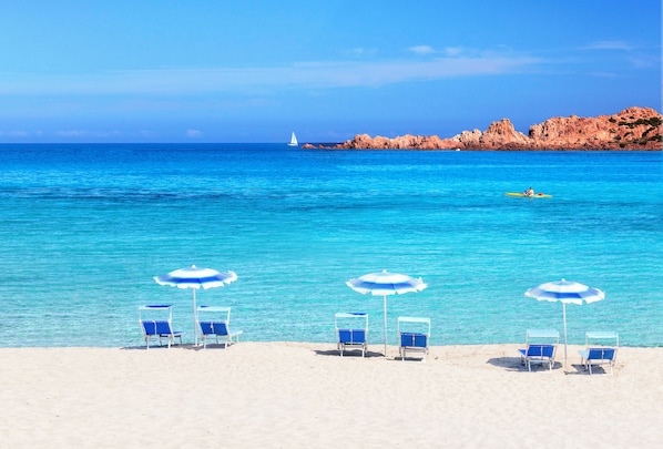 On the beach, white sand, free beach shuttle, beach umbrellas