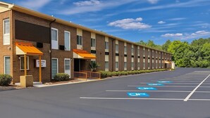 A multi-story hotel with a parking lot marked for handicapped parking.