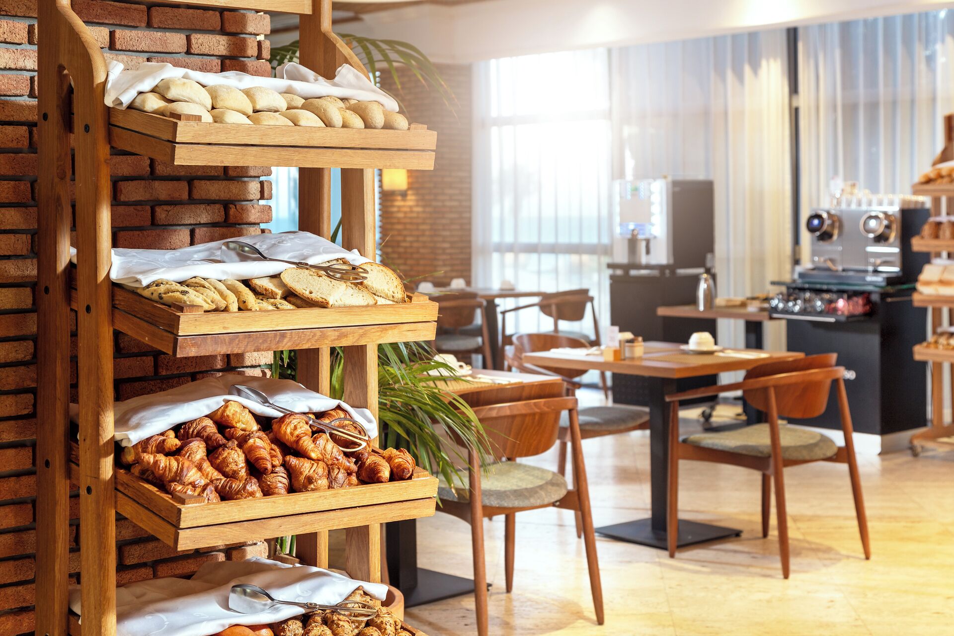 A bakery display with bread, pastries, and croissants.
