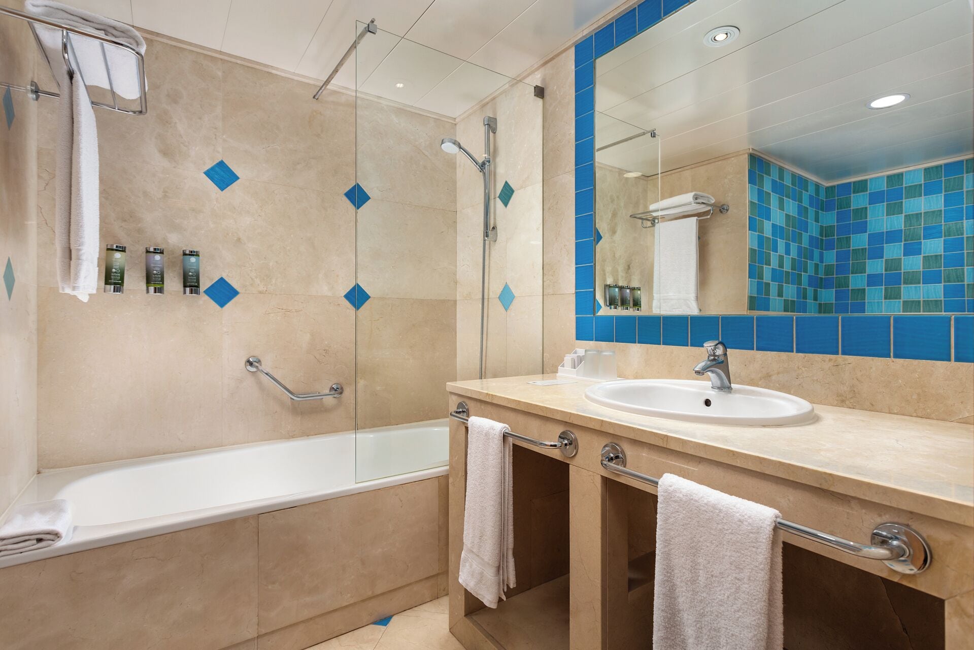 A modern bathroom with a bathtub, a sink, and a shower.