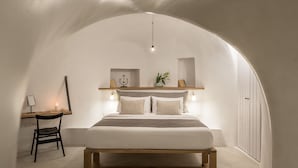Een slaapkamer met een bed, een bureau en een stoel.