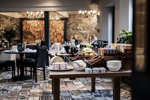 A breakfast buffet with various food items and condiments. - Swan Hotel (Cirencester)