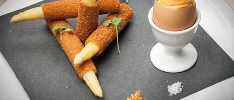 A dessert plate with croquettes and a scoop of ice cream.