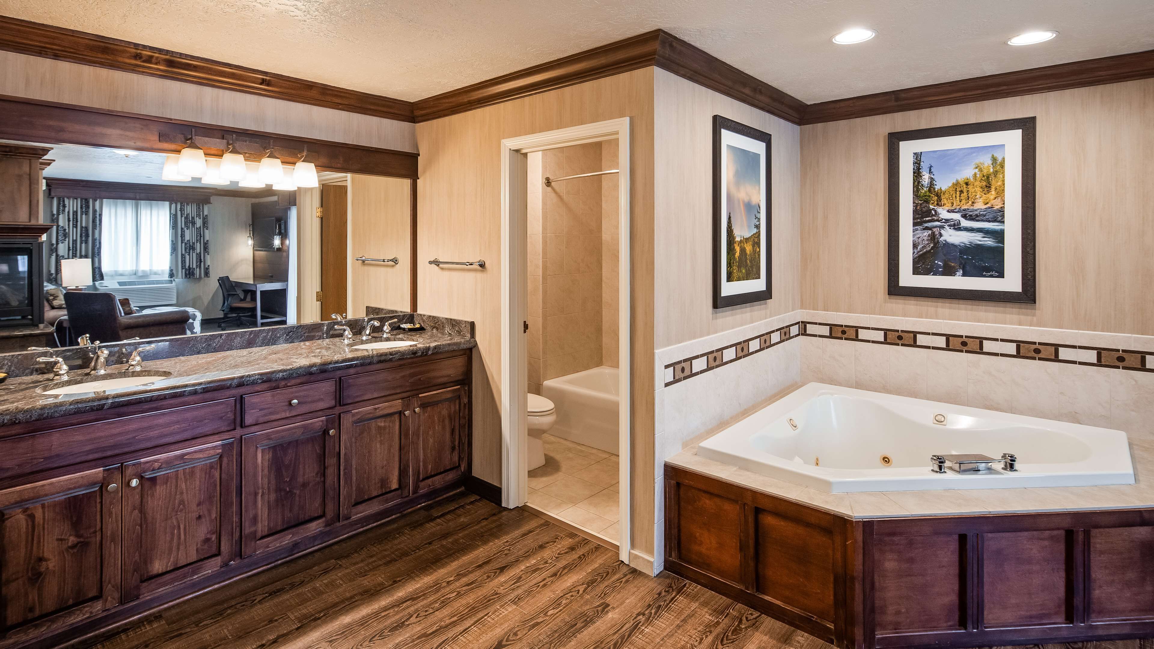 A modern bathroom with a large vanity, a bathtub, and a shower.