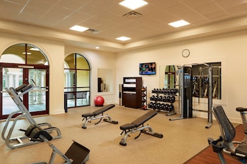 A spacious living room with a fireplace, comfortable seating, and a large TV mounted on the wall. at Hilton Grand Vacations Club Tuscany Village Orlando