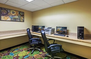 A hotel office with a desktop computer, printer, and two monitors. There are two chairs and a carpeted floor. - Holiday Inn Express Hotel & Suites Pharr by IHG (Pharr)