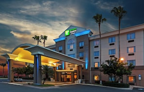 A Holiday Inn Express & Suites hotel with a modern design, featuring a covered entrance and multiple floors. - Holiday Inn Express Hotel & Suites Pharr by IHG (Pharr)