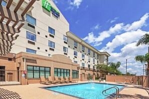 A hotel with a swimming pool, lounge chairs, and a clear blue sky. - Holiday Inn Express Hotel & Suites Pharr by IHG (Pharr)