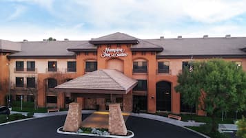 Classic hotel with a central entrance, flanked by windows, and a distinctive curved roof.