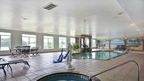 An indoor swimming pool with a view of the beach, surrounded by lounge chairs and a poolside bar. - Hampton Inn Corpus Christi-Northwest I-37 (Corpus Christi)