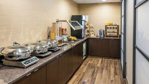 A modern kitchen with stainless steel appliances, a built-in oven, and a variety of food items on the counter. - Residence Inn by Marriott Rochester Mayo Clinic Area (Rochester)