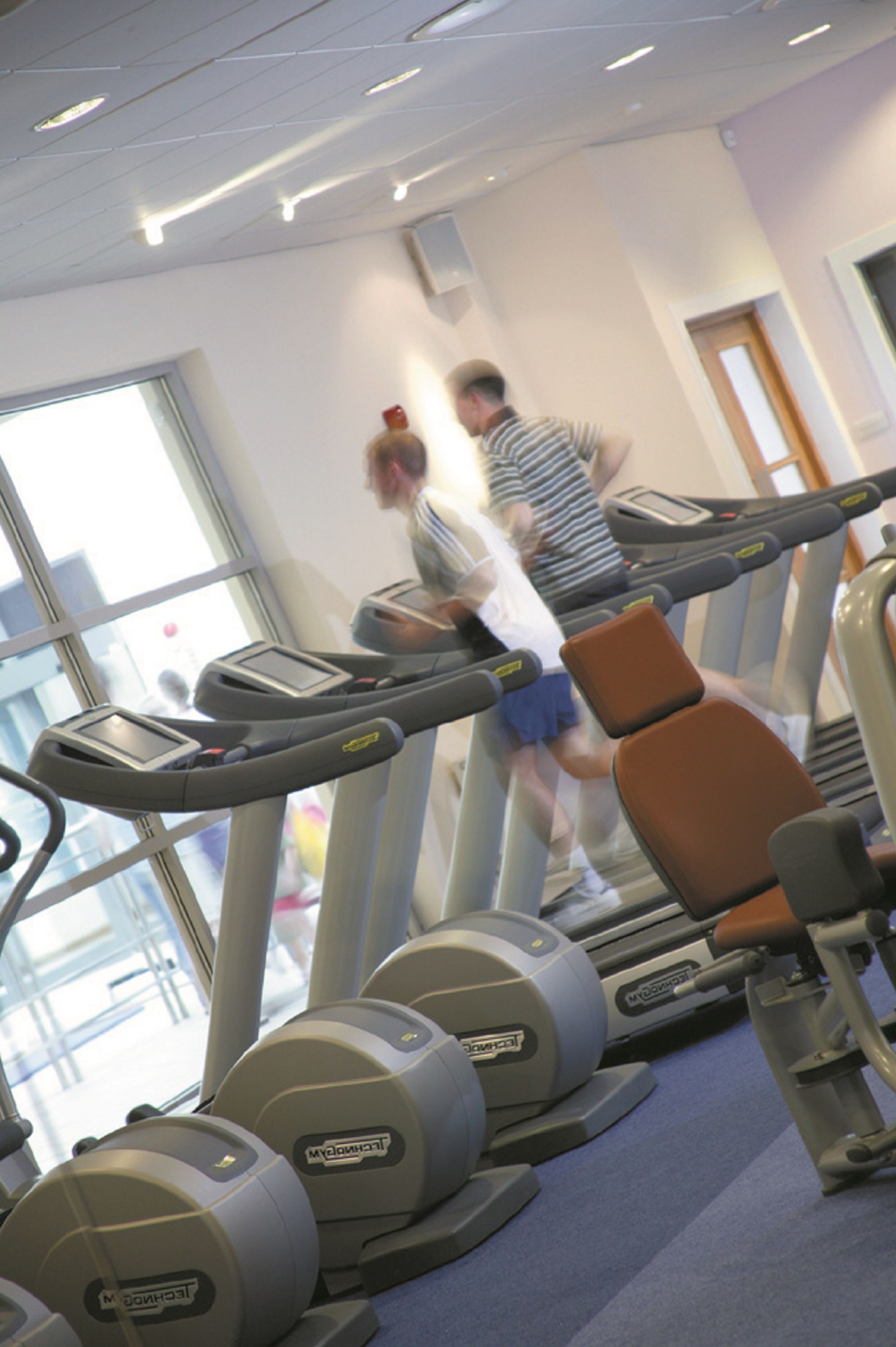 A gym with treadmills and exercise equipment.