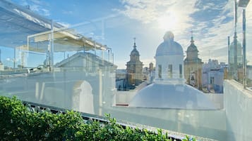 A view from a window overlooking a cityscape with domed buildings and a clear sky.
