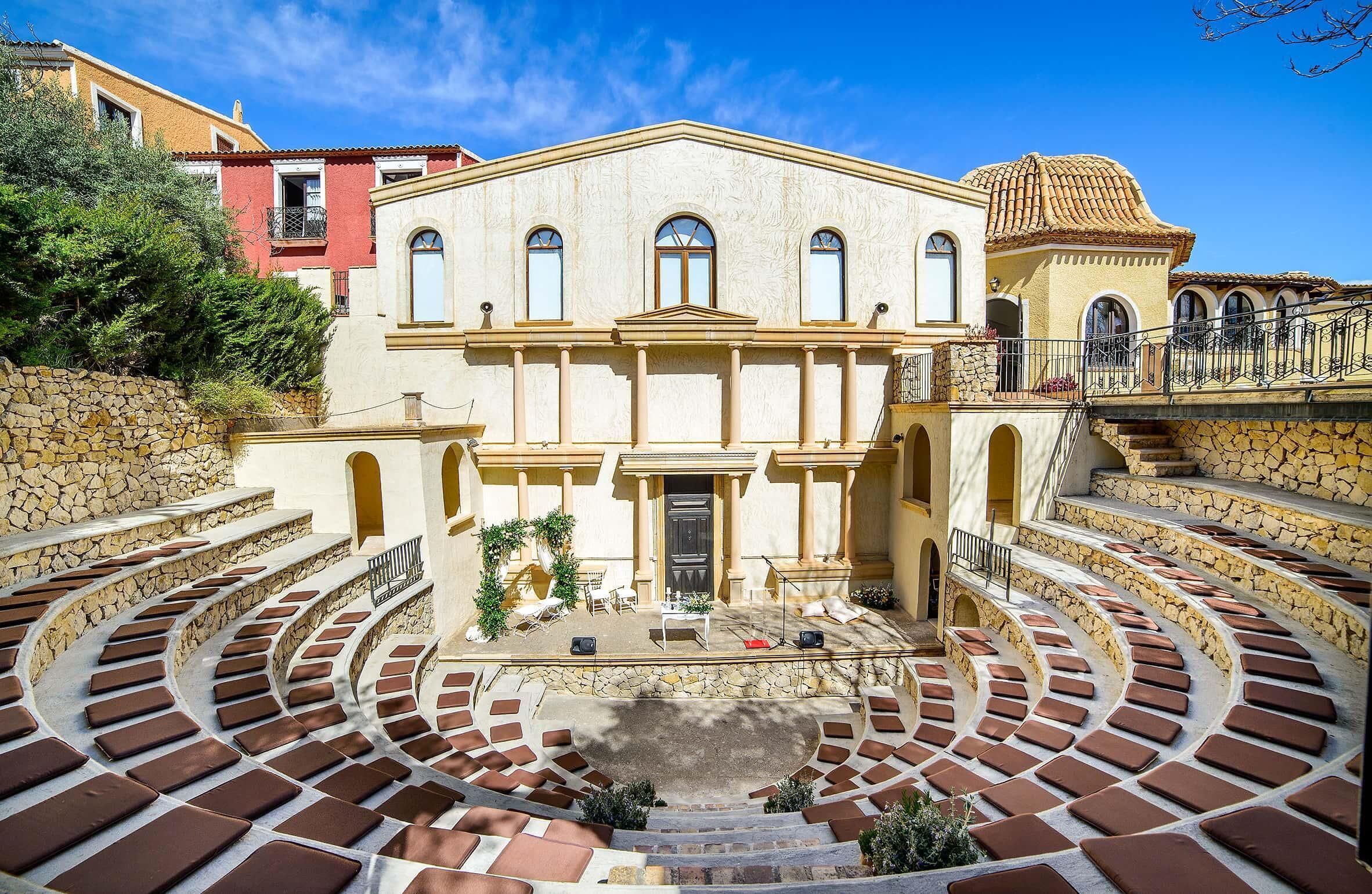 A historic building with a central courtyard, stone steps, and a traditional architectural style.