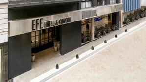 A hotel with a modern facade, multiple balconies, and a sign reading "EFE HOTEL & COWORK".