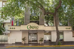A hotel entrance with a sign reading "Hotel Carillo" and three stars.