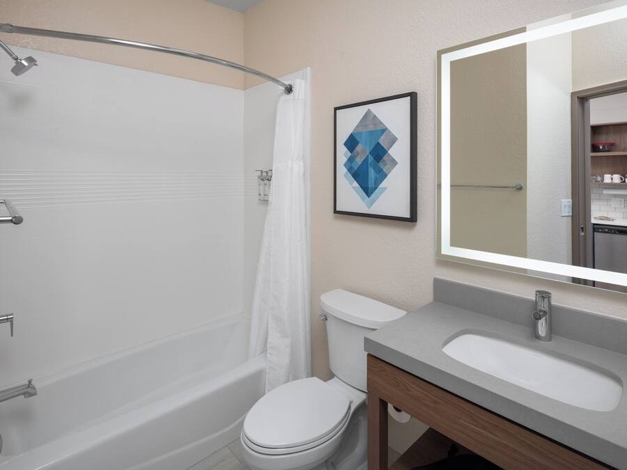 A modern bathroom with a bathtub, toilet, and sink.
