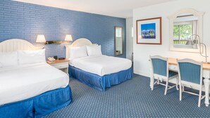 A hotel room with two beds, a desk, and a chair. - Ocean Park Inn (Eastham)