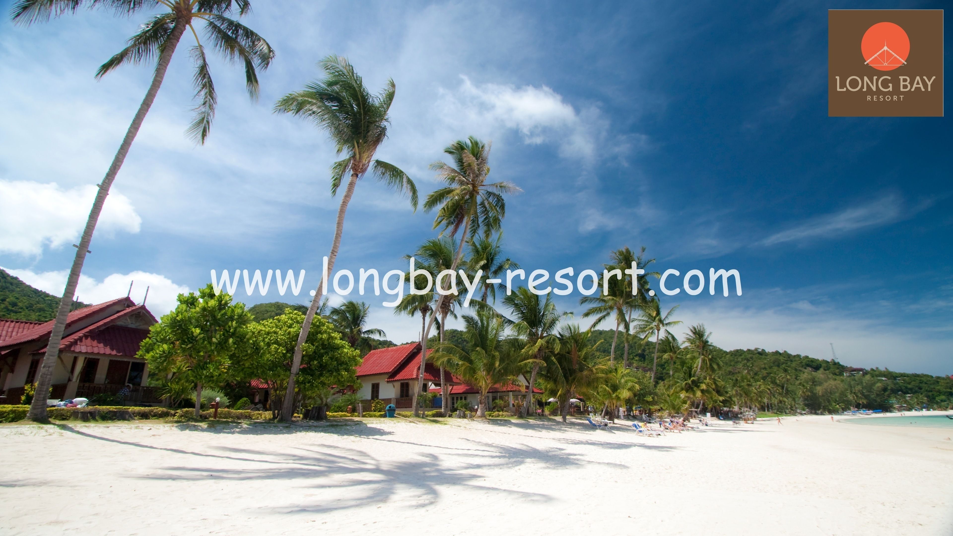 A beach with palm trees, a red-roofed building, and a clear sky.