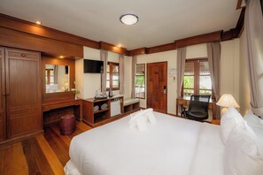 Relax in comfort with a large bed, desk, and TV, surrounded by a warm and inviting space.