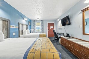 A hotel room with two beds, a desk with a chair, a dresser, a television, and a door. - Days Inn & Suites by Wyndham Terre Haute (Terre Haute)