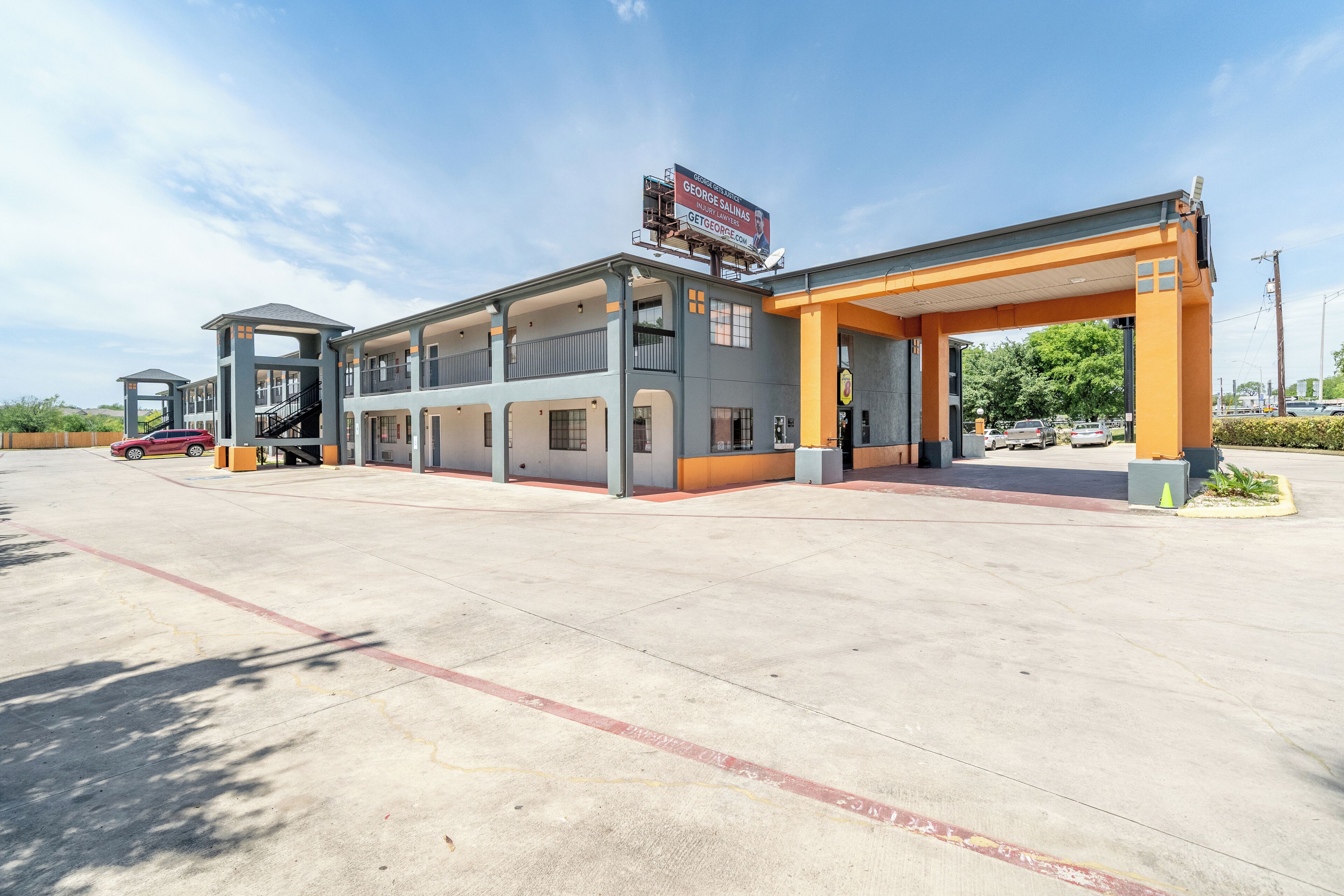 A multi-story hotel with a gas station attached.