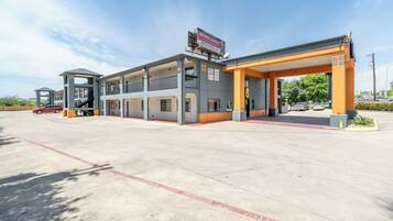 A multi-story hotel with a gas station attached.