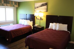 A hotel room with two beds, green walls, and a window with blinds. - Express Inn (Vallejo)