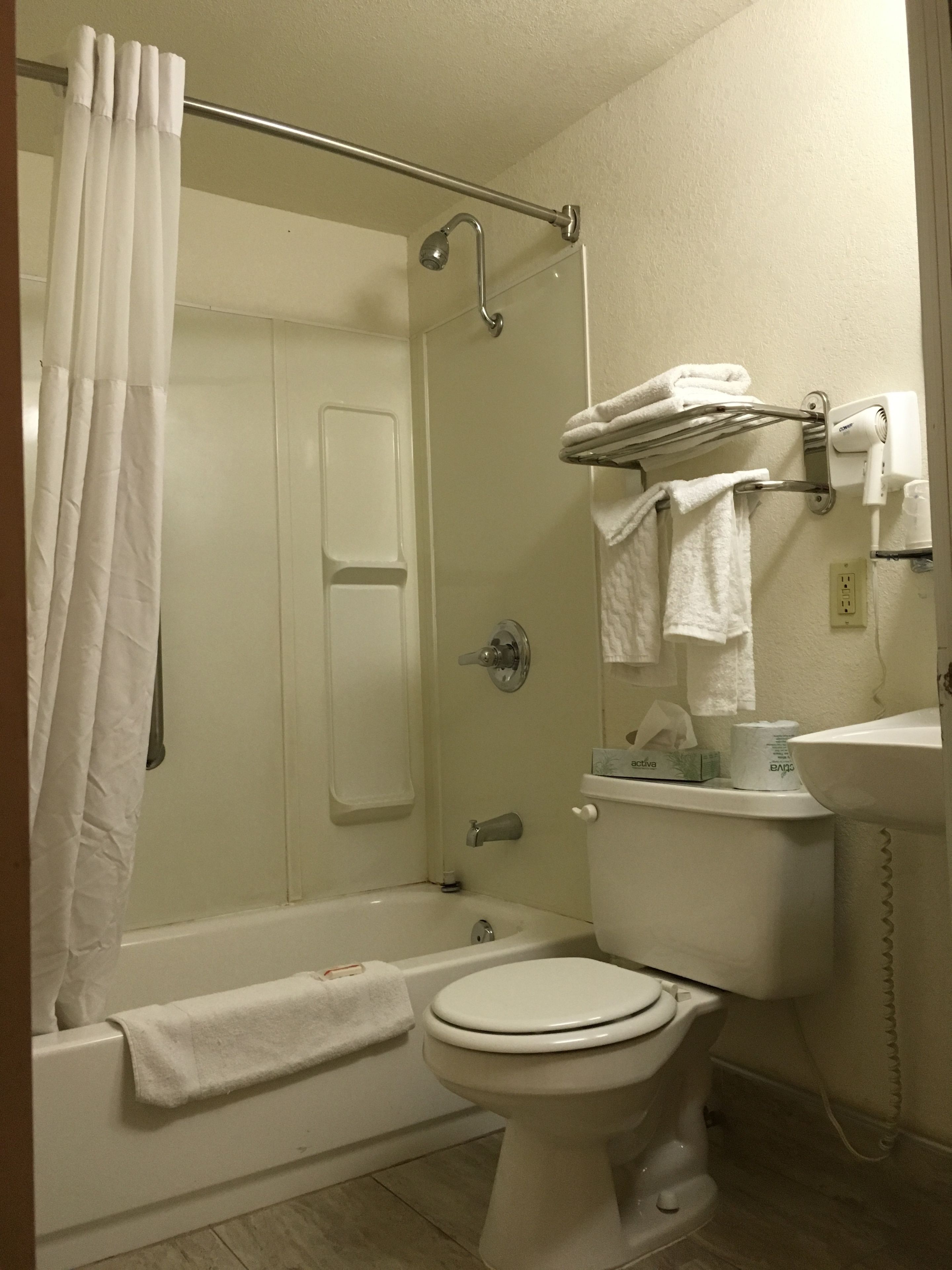 A bathroom with a bathtub, toilet, and shower.