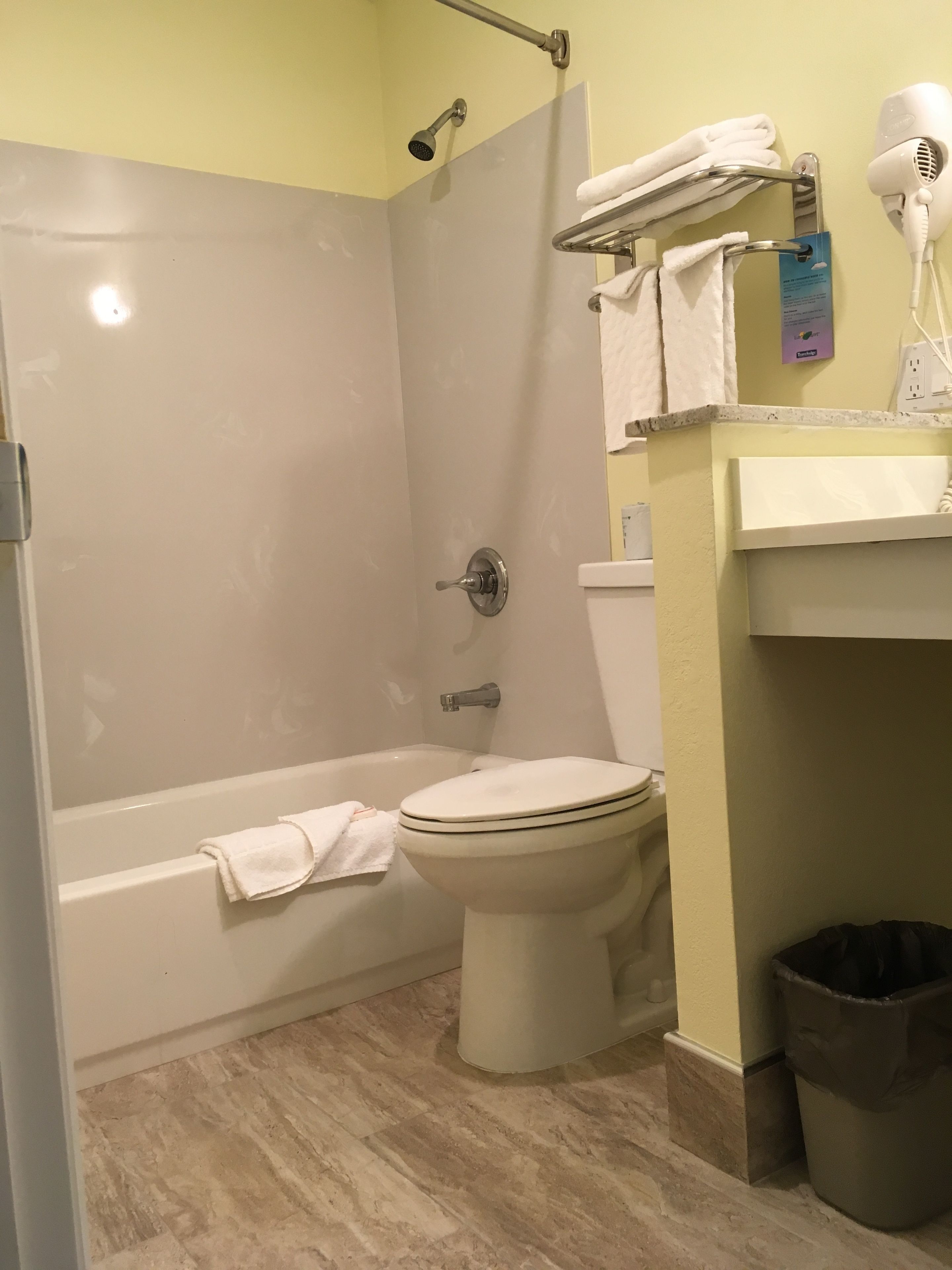 A bathroom with a bathtub, toilet, and a shower.