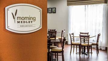 A breakfast sign for 'Morning Medley' and a dining area with wooden chairs and tables.