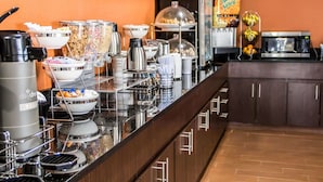 A buffet setup with various food items and appliances.
