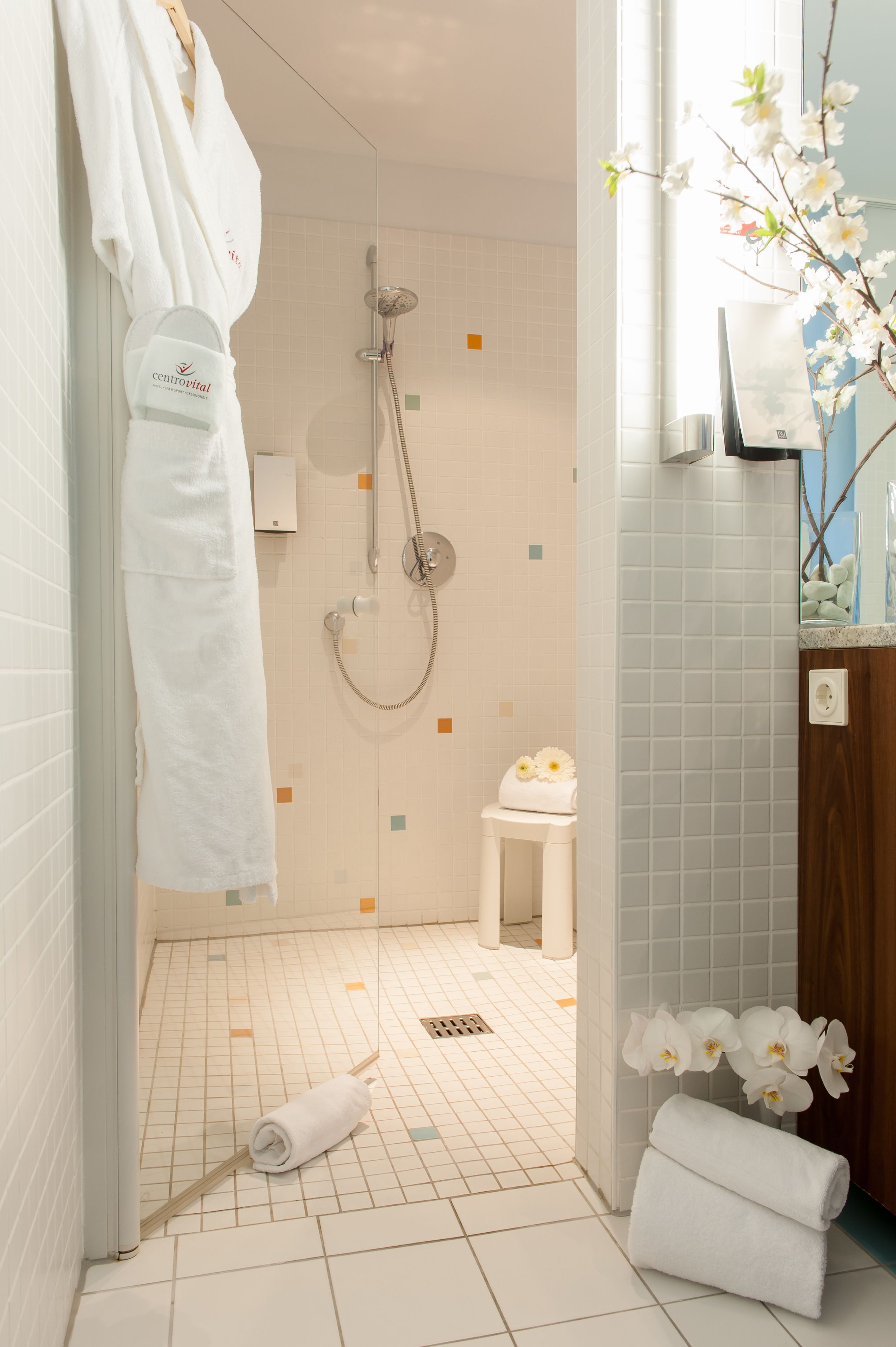 A bathroom with a shower, a toilet, and a sink.
